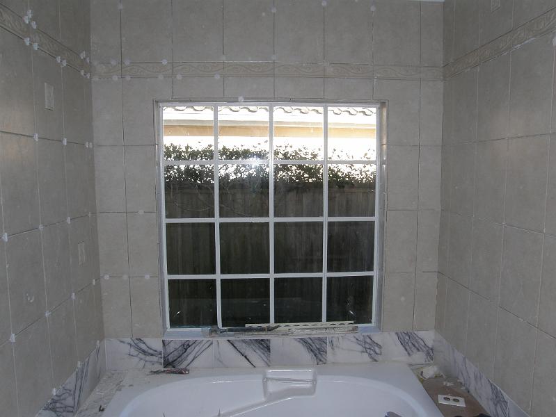13 Tile Going Around Bathtub and Window.JPG
